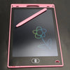 A pink LCD writing tablet with a black screen shows a green flower drawn on it, and a pink stylus rests diagonally across the