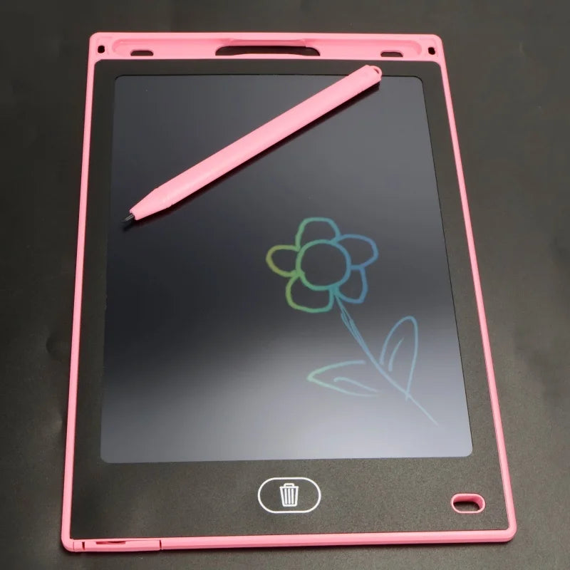 A pink LCD writing tablet with a black screen shows a green flower drawn on it, and a pink stylus rests diagonally across the