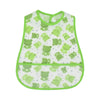 A white baby bib with a green cartoon pattern of frogs and grass.
