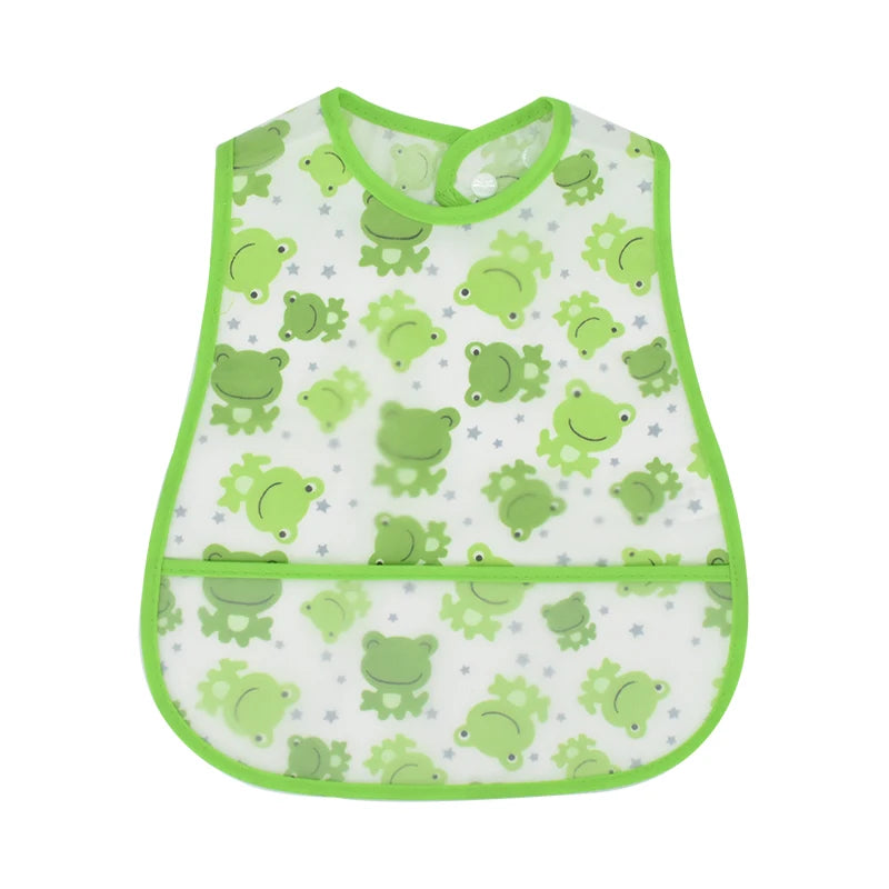 A white baby bib with a green cartoon pattern of frogs and grass.