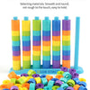 A colorful rainbow stacking ring toy set with various colored rings and a vertical holder.