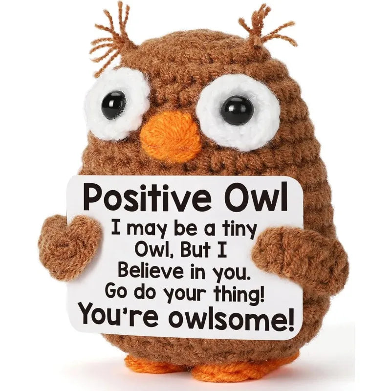 A handmade crochet owl toy with large eyes and brown fur, used as inspirational desk decor.