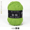A ball of bright lime green milk cotton yarn labeled with Chinese characters and size 48