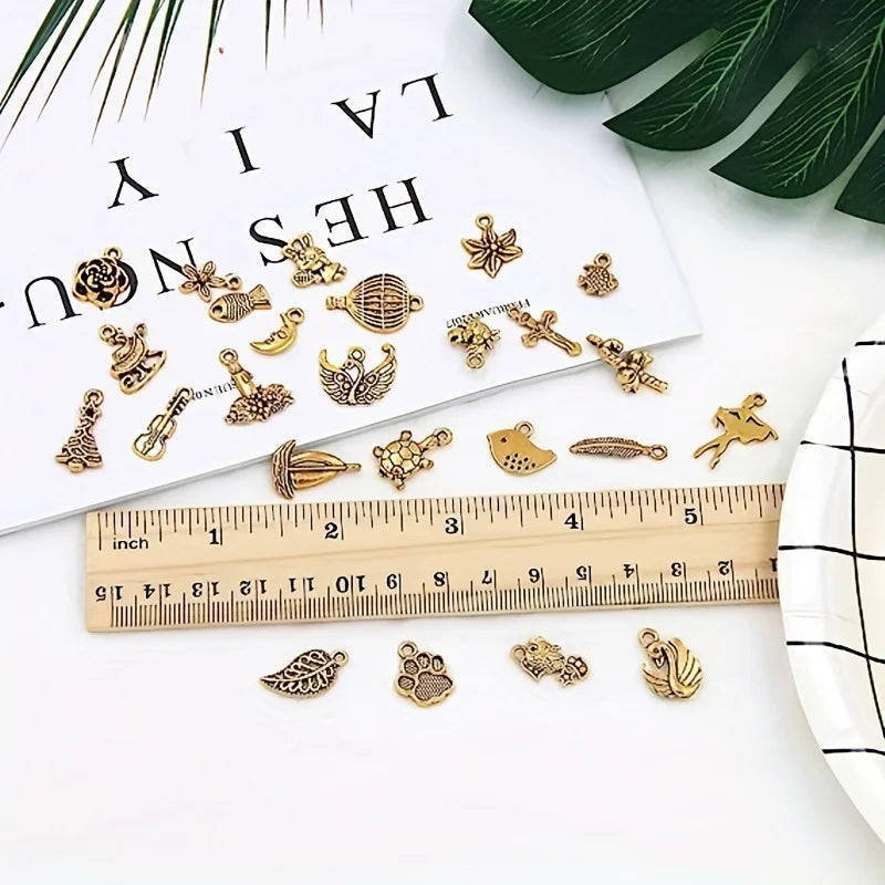 A collection of 90 pieces of silver-tone jewelry making components including bangles and charms laid out on a white surface n