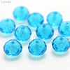 A collection of bright blue crystal glass beads and round spacers for jewelry making