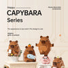 A set of wooden building blocks shaped like capybaras, including a large figure and smaller animals.
