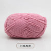 A ball of pink pre-dyed milk cotton yarn used for knitting and crochet.