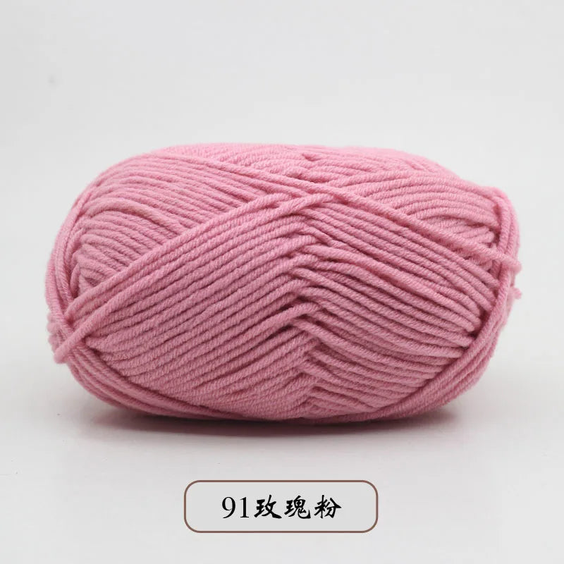 A ball of pink pre-dyed milk cotton yarn used for knitting and crochet.