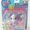 A plastic package containing three small purple and white animal figures for sale.