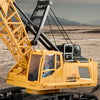 A yellow remote control spray crane truck is shown on a dirt terrain, demonstrating its ability to handle complex terrains.