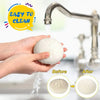 Hands demonstrate cleaning a dumpling squishy stress ball with a mini steamer before and after.