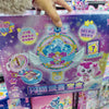 A packaged collectible figure featuring a purple and blue design with an ornate silver light theme.