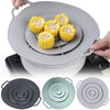 A hand places a silicone spill stopper lid onto a pot or pan, showing the lid's design and texture.