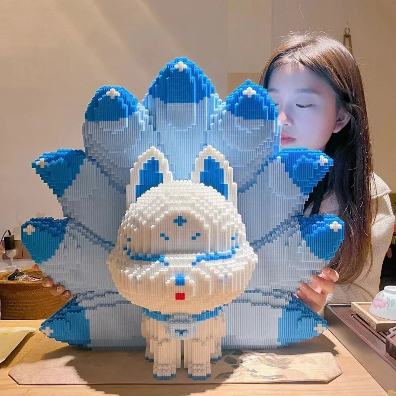A woman holds a large, white and blue Nine-Tailed Fox building block set featuring a fox character.