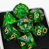 A collection of green resin dice, including d10s and d12s, displayed in a dark container.