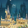 A detailed model of a medieval castle built from yellow and gray building blocks on water.
