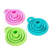 A set of three collapsible silicone funnels in pink, blue, and green.