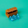 An open building block treasure chest revealing blue gemstone-like crystals.