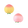 A squishy stress relief toy shaped like a peach, featuring a gradient of yellow and pink.