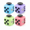 A set of three fidget cubes in blue, purple, and pink with magnetic buttons.