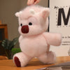 A pink West Highland calf plush toy with floppy ears and a small snout is displayed on a wooden surface.
