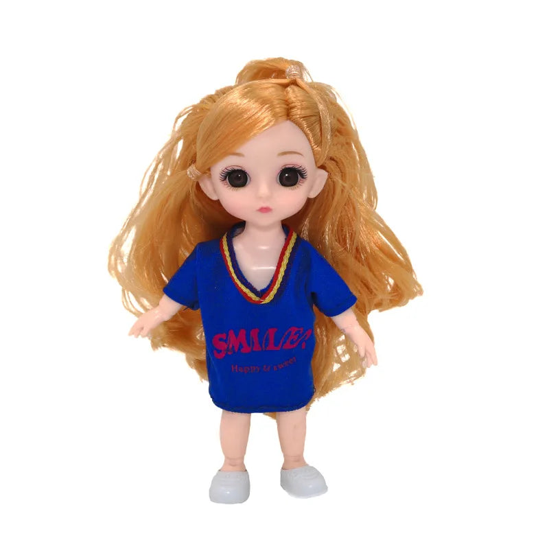 An orange-haired Articulated BJD princess doll wearing a blue shirt.