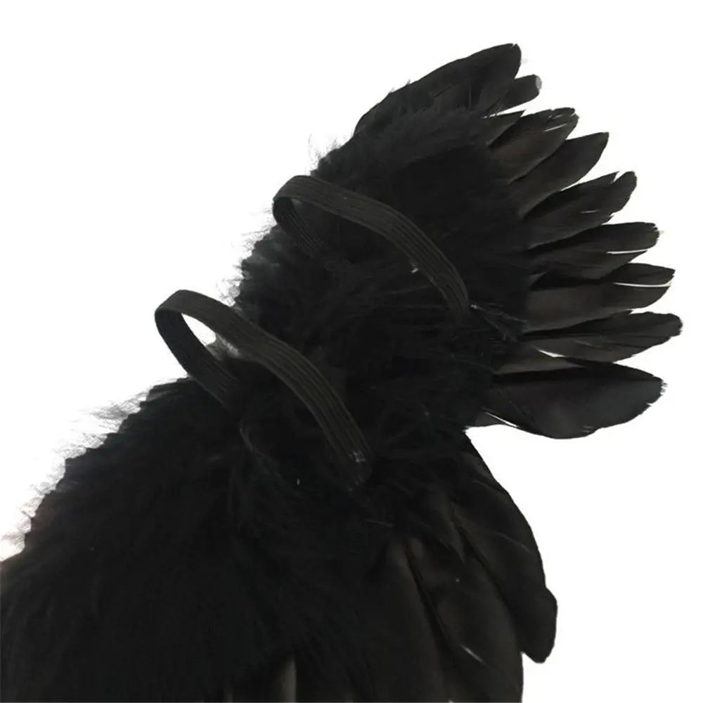 A close-up of black mini feather angel wings for dolls and crafts.