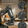 A black RC excavator arm with interchangeable attachments shown in a living room setting.
