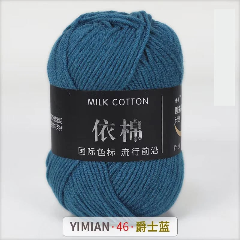 A skein of blue milk cotton yarn is shown, labeled with Chinese characters and the brand YIMIAN.