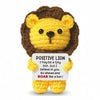 A yellow crochet lion doll with brown fur and a sign that reads Positive Lion I may be a tiny lion but I believe in you go ah