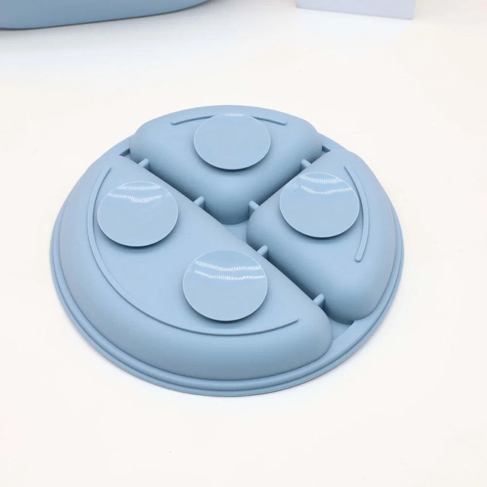 A light blue silicone baby tableware set with six round silicone dishes arranged in a triangular pattern.