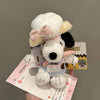 A white Snoopy plush keychain charm is shown against a light background.