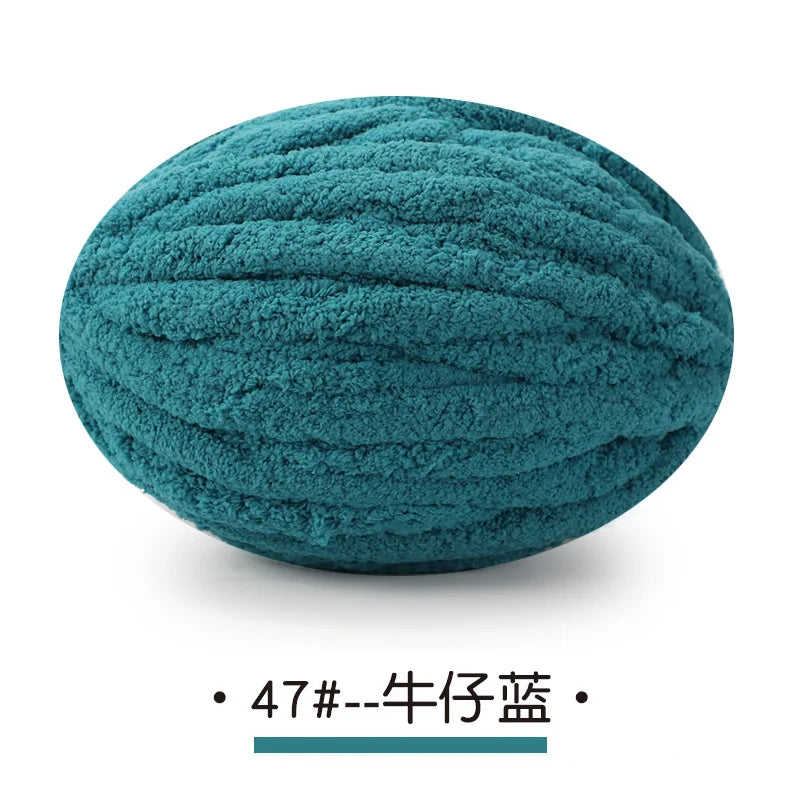 A ball of teal chunky chenille yarn used for hand knitting projects.