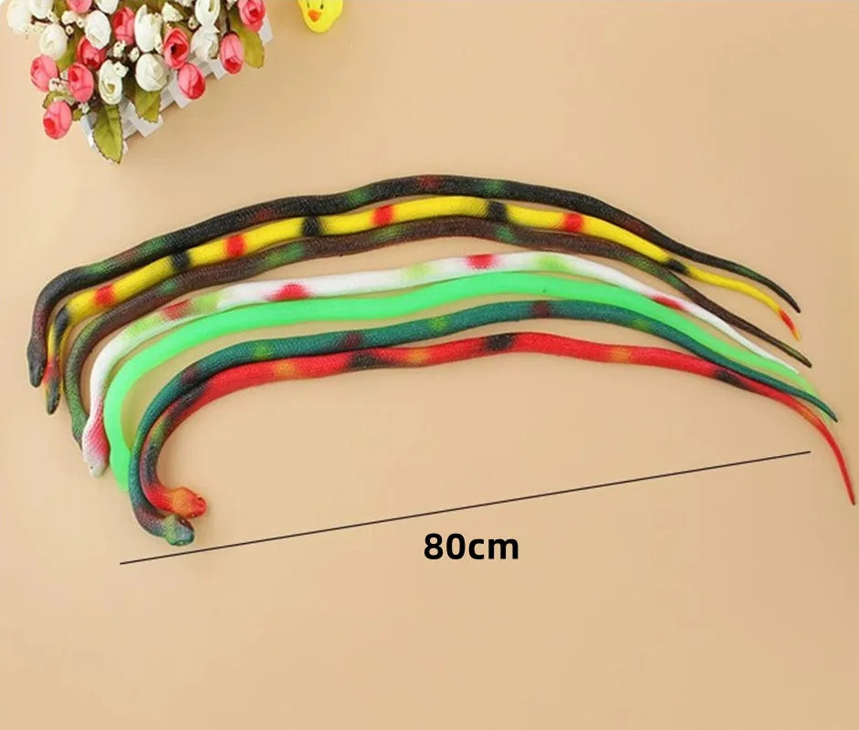 A display of colorful rubber snakes of varying lengths and patterns laid out on a light background.