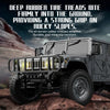 A rugged off-road vehicle with deep rubber tire treads climbing on rocky terrain.