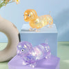 A golden squishy toy shaped like a dachshund resting on a light blue box and a purple stand.