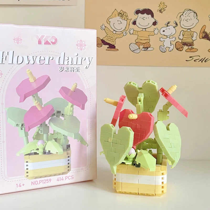 A pink box for a miniature flower bouquet building block set featuring green and pink floral elements.