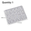A silicone mold tray containing various heart-shaped and decorative metal-style shapes for resin casting.