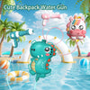A cute green dinosaur backpack water gun toy is shown spraying water in a pool with a rainbow arch and tropical plants.
