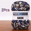 A ball of dark blue and white patterned soft chunky t-shirt yarn for crochet and knitting, packaged as a 2-pack.