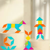 A wooden geometric shape puzzle featuring colorful blocks arranged in various figures on a light background.