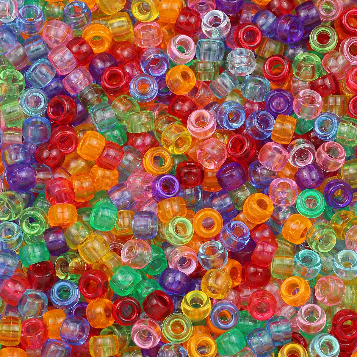A close-up view of a large pile of multicolor pony beads in various shades of red, orange, green, and purple.