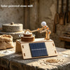 A wooden model kit of a lunar rover powered by a solar panel sits on a rustic table.