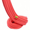 A close-up of a bright red, stretchy slime product with green cake decorations, shown in a coiled form.