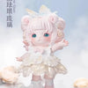 A pink collectible figurine of a girl with fluffy hair and a white dress floating on a reflective surface.
