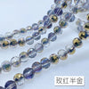 A string of 10mm Austrian crystal beads with AB coating in purple and gold tones.