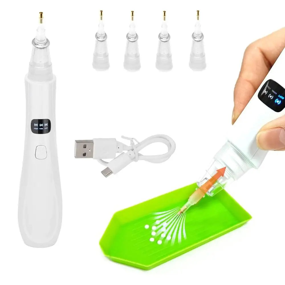 A white electric diamond painting pen and several replacement tips are shown next to a hand using the pen on a green tray.