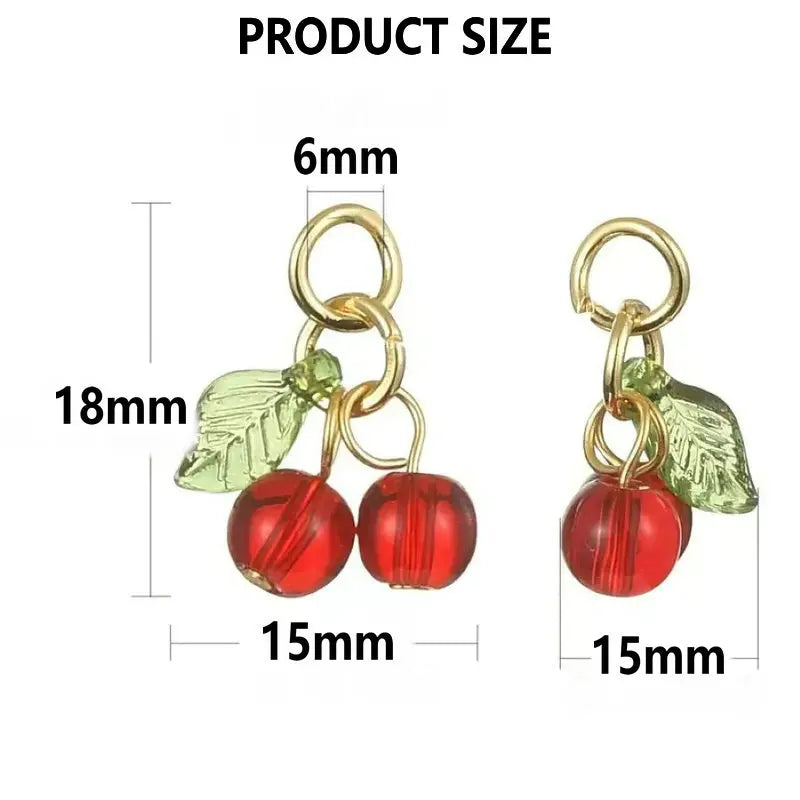 A set of red cherry glass charms with gold-colored jump rings and leaves, shown with size measurements.