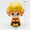 A figure set of Tanjiro and Nezuko from Demon Slayer, featuring yellow hair and orange clothing.