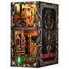 A dark, ornate box set featuring a diorama of a haunted hotel interior with detailed decor and gothic framing.